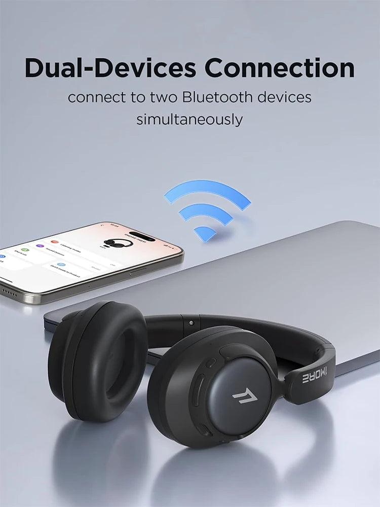 Black wireless headphones with smartphone showing Bluetooth connection on a light gray background