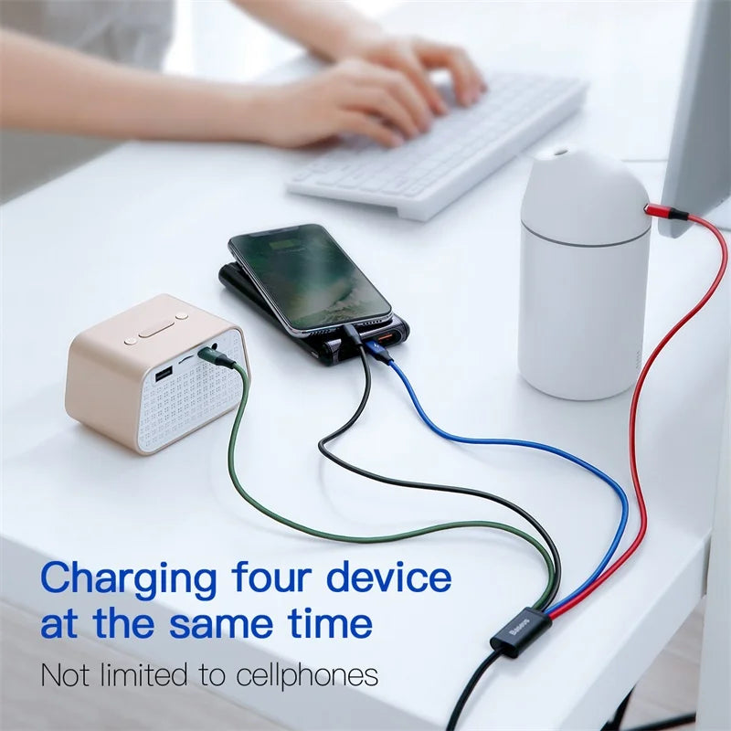 Charging station with multiple devices on a desk, including a smartphone and computer mouse.