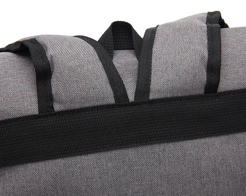 Gray duffel bag with black straps on a white background