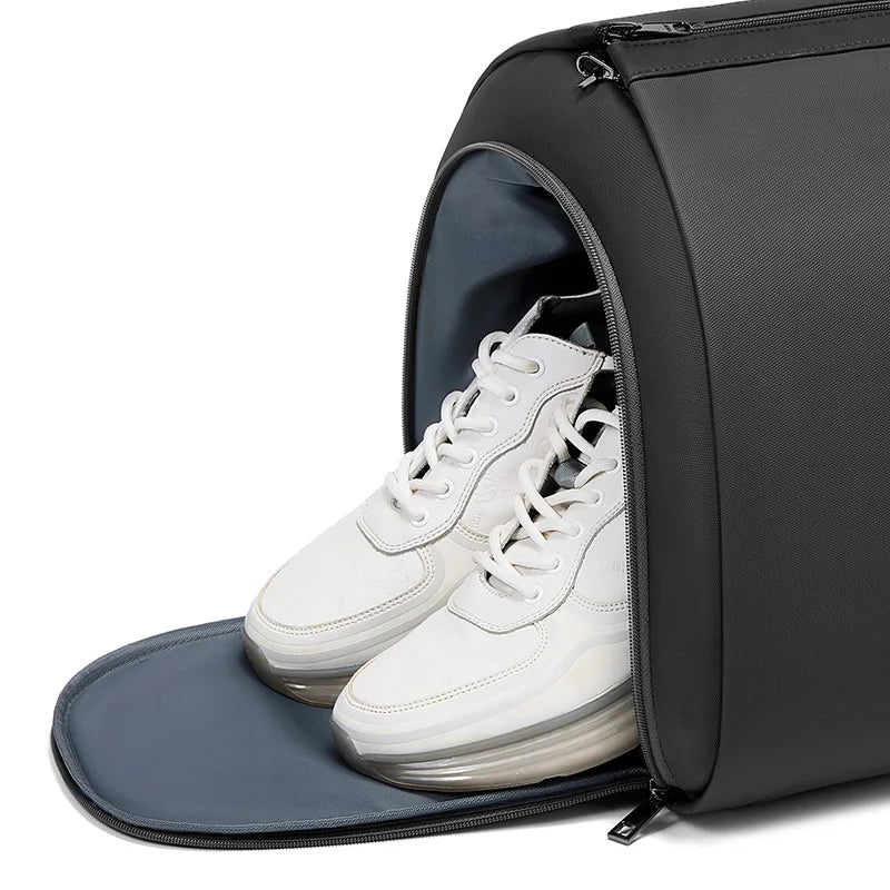 Black travel shoe bag with white sneakers inside on a white background