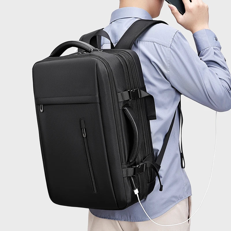 Person wearing a black backpack with a light gray background