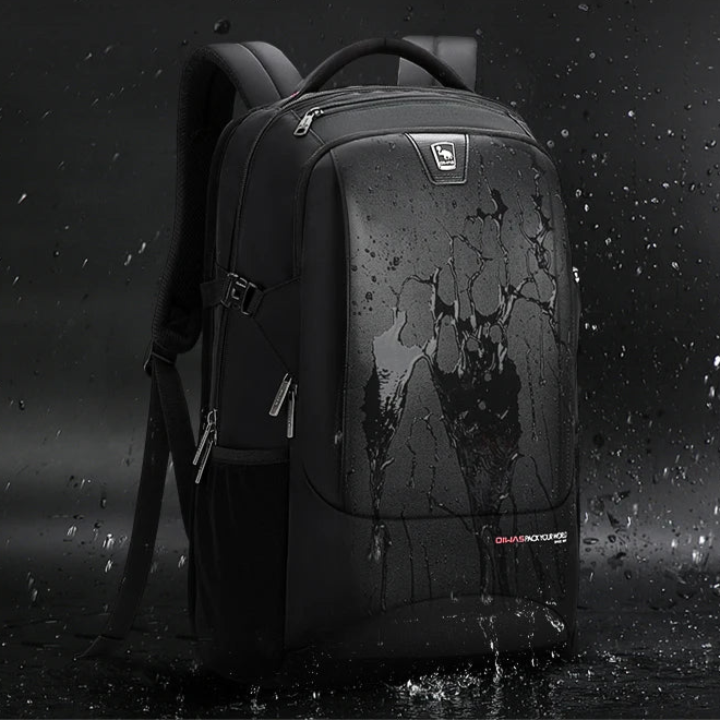 Black backpack with water splashes on a dark background, emphasizing waterproof material.