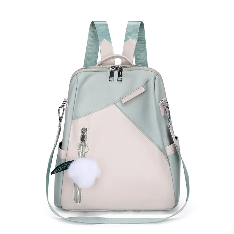 Light blue and beige backpack with a pom-pom on a white background