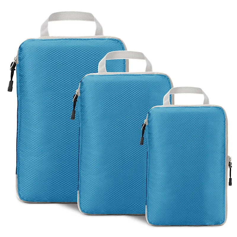 Three blue packing cubes with handles on a white background