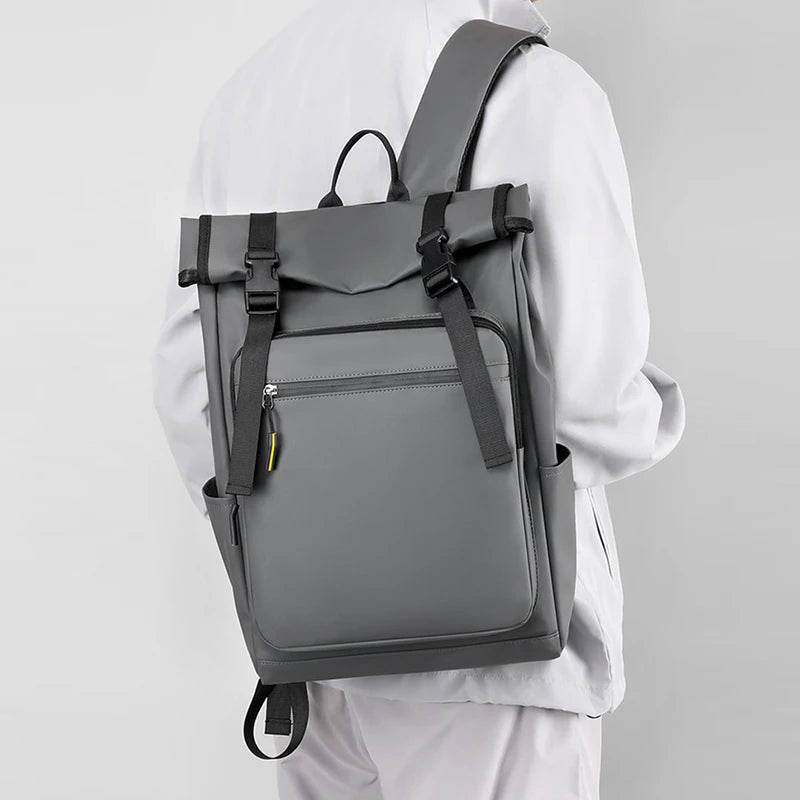 Person wearing a gray backpack on a plain background
