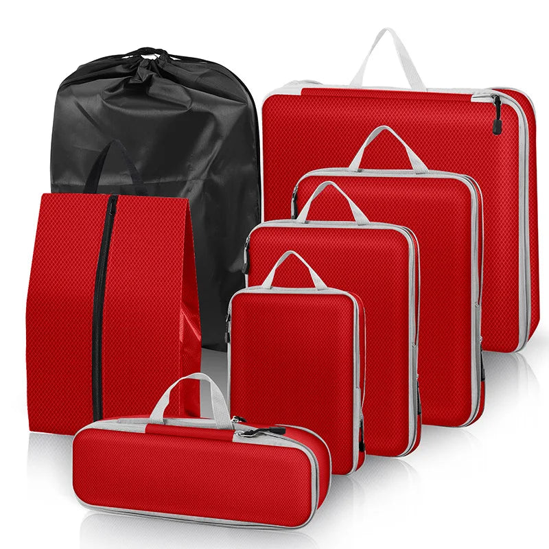 Set of red packing cubes with black drawstring bag on a white background