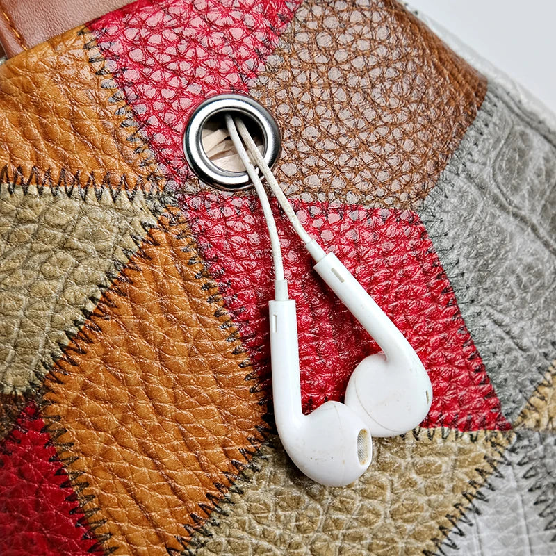 White earphones plugged into a patchwork-patterned device.