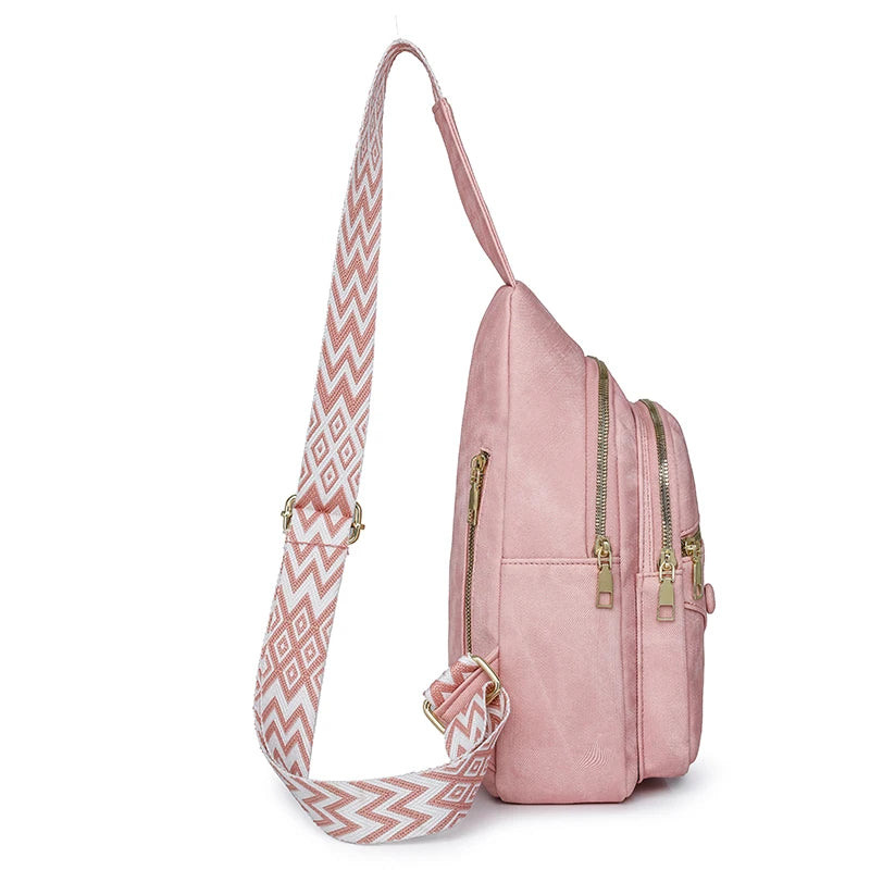 Pink backpack with a patterned strap on a white background