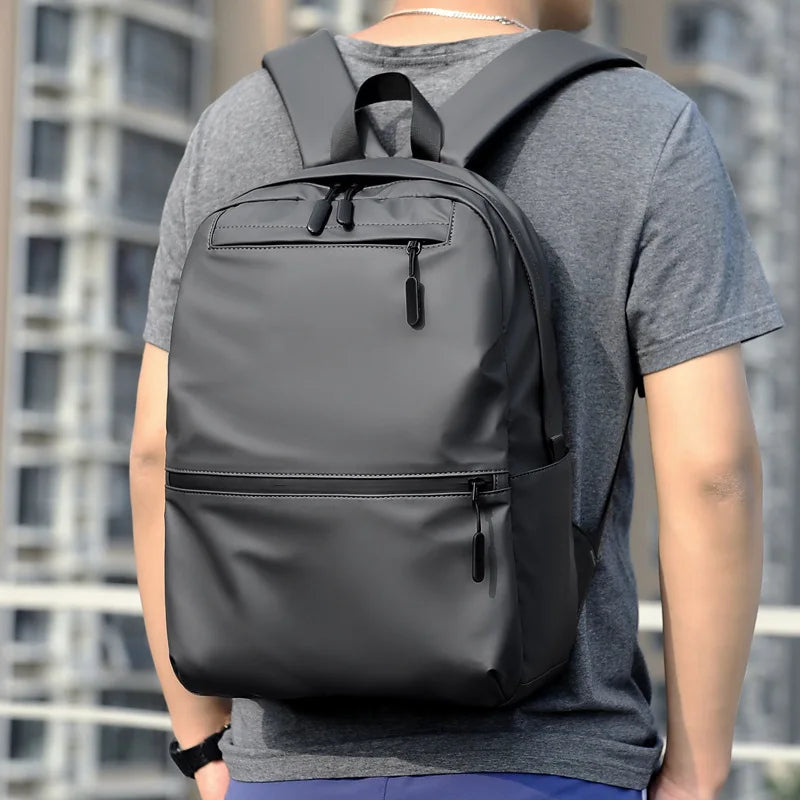 Stylish black laptop backpack designed for students and travelers, showcasing a modern unisex design.