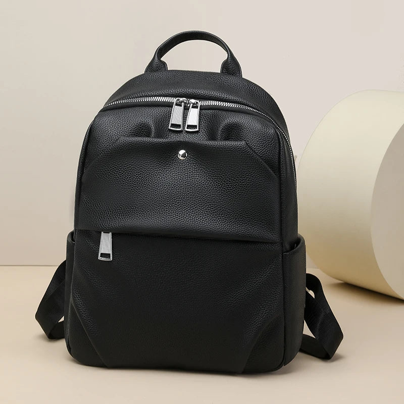Black leather backpack on a beige background