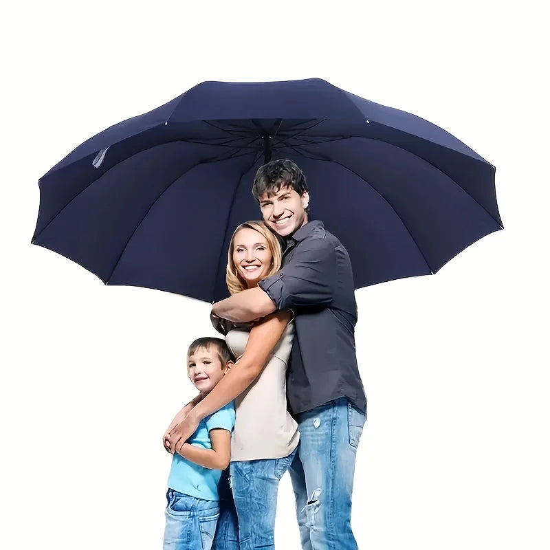 Family of three under a large navy blue umbrella on a white background
