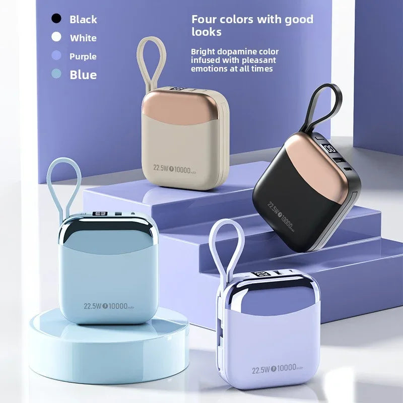Four portable power banks in different colors on a light purple background