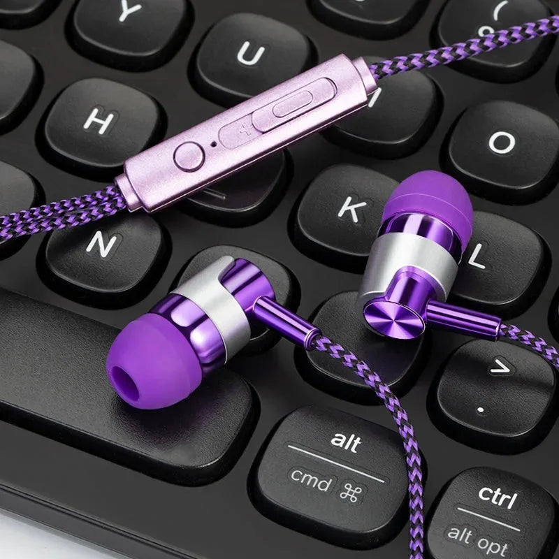 Purple and silver earphones on a black keyboard
