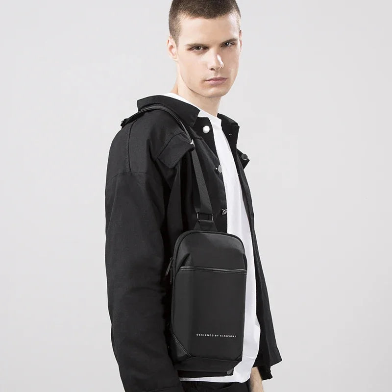 Man wearing a black backpack with a plain background