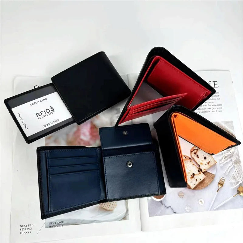 Four open leather wallets in black, red, blue, and orange on a white surface.