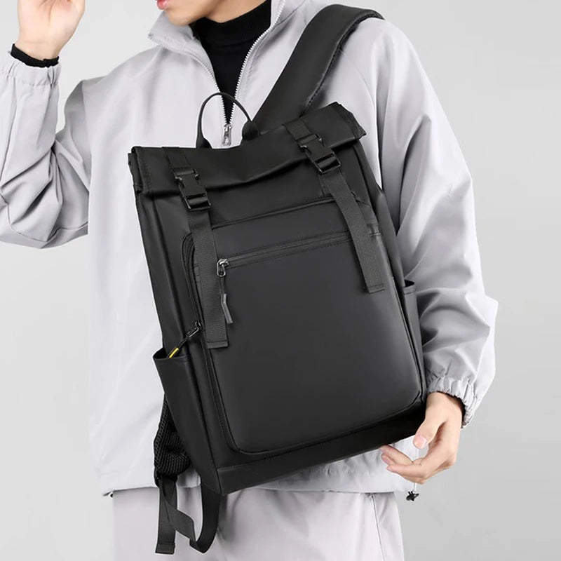 Person wearing a black backpack on a plain background