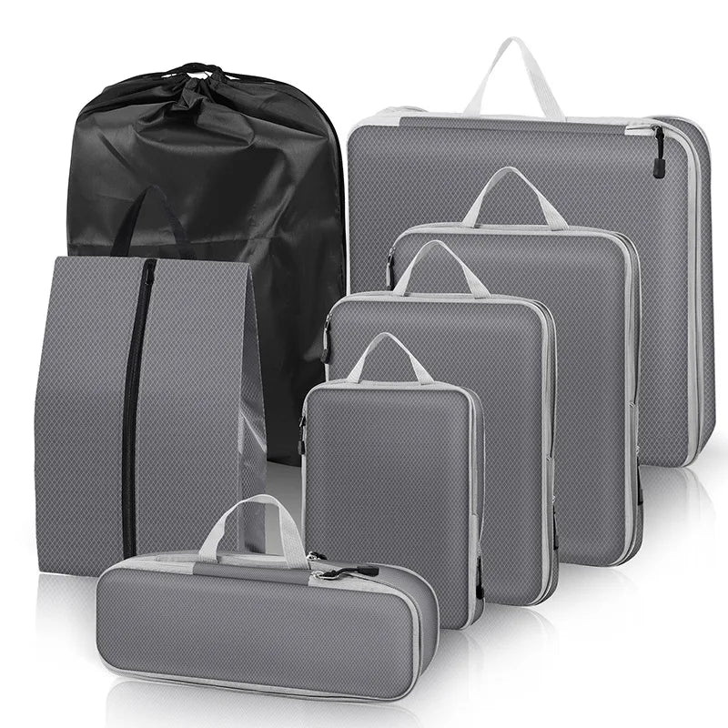 Set of gray packing cubes and a black garment bag on a white background