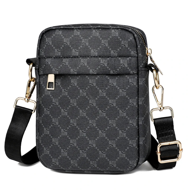 Black patterned crossbody bag with gold accents on a white background