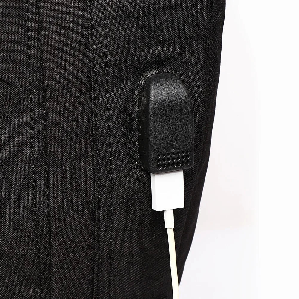 Close-up of a black electronic device attached to a black jacket with a white background