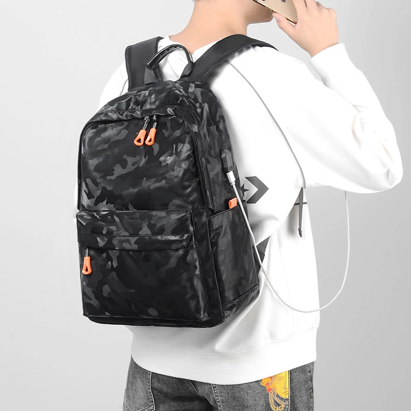 Person wearing a black camouflage backpack with orange accents on a light gray background