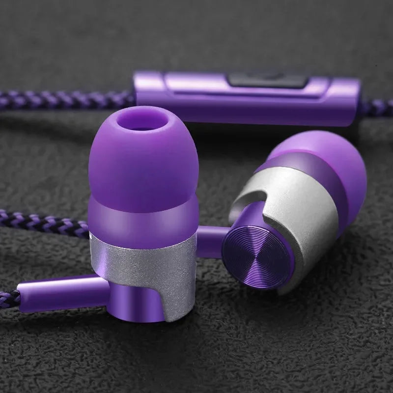 Purple and silver earbuds on a dark textured surface