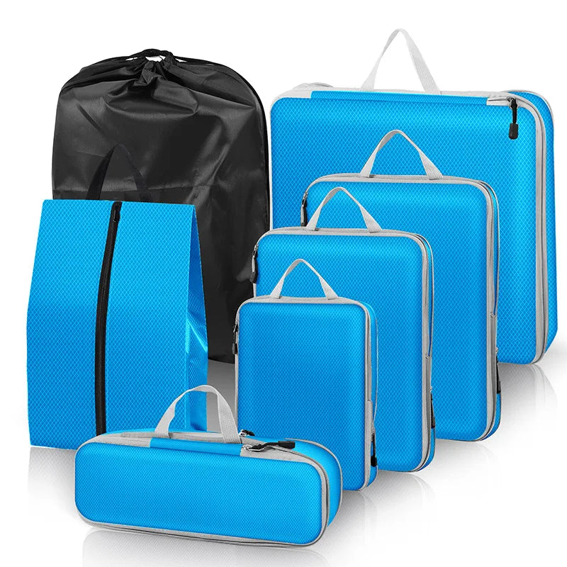 Set of blue packing cubes with black drawstring bag on a white background