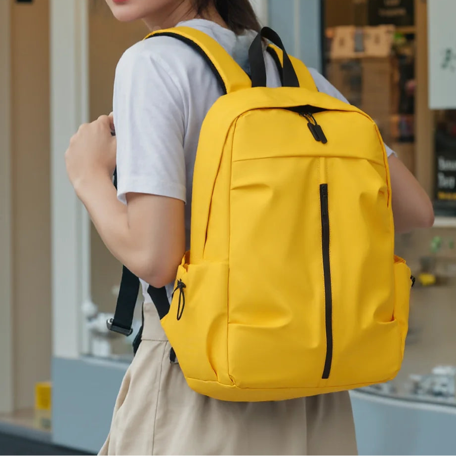 Person wearing a yellow backpack indoors