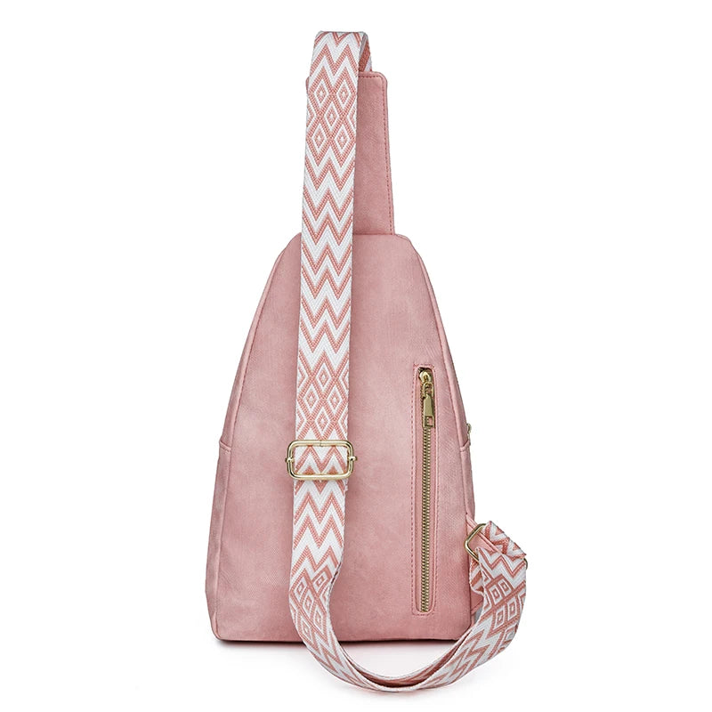 Pink sling bag with a white and red patterned strap on a white background
