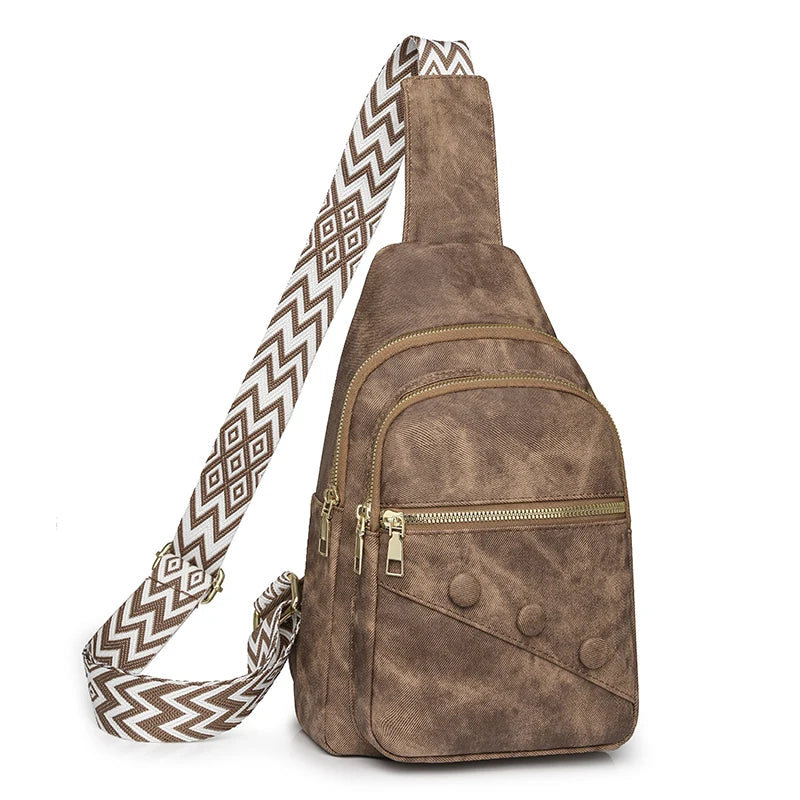 Brown suede sling bag with a patterned strap on a white background