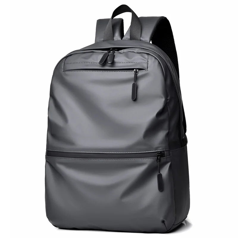 Stylish gray waterproof backpack with a large capacity, perfect for students and travelers.