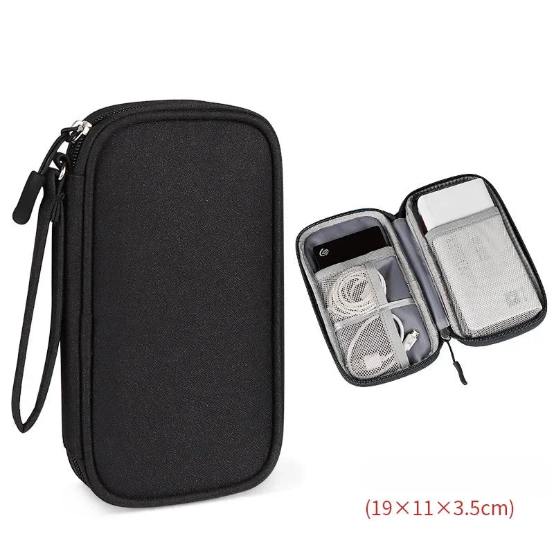 Black travel organizer with open compartment showing electronic devices on a white background