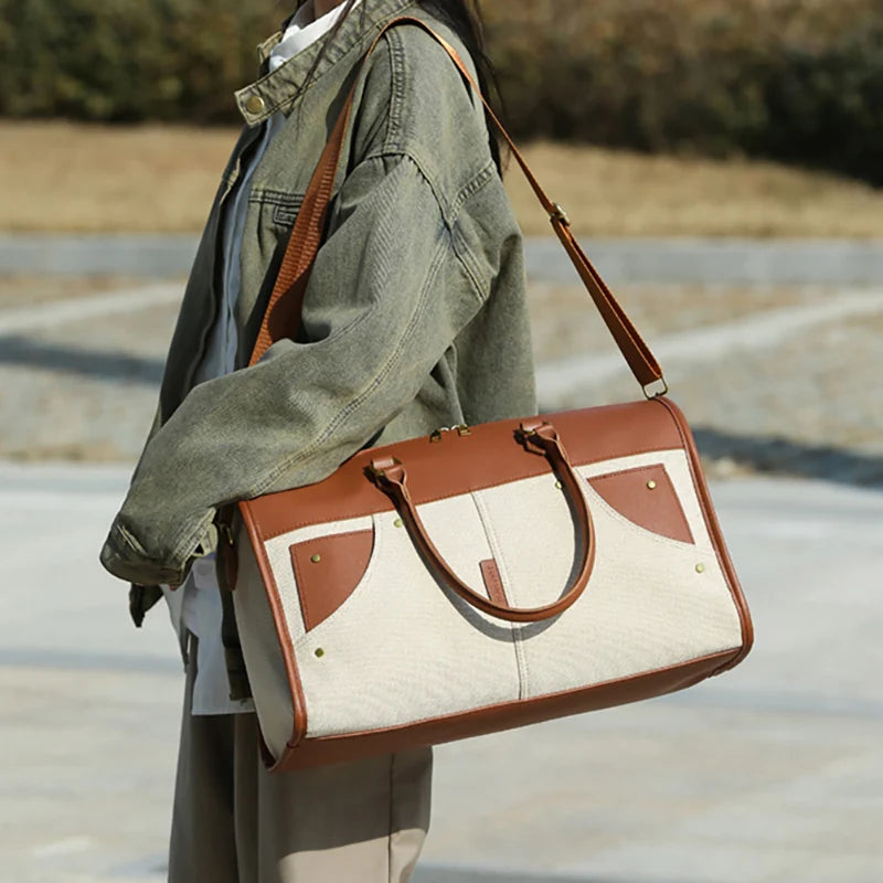 Person holding a brown and beige handbag outdoors