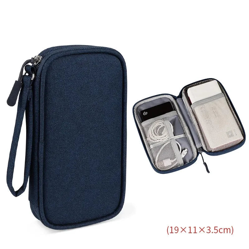 Navy blue travel organizer with open compartment showing electronic devices on a white background