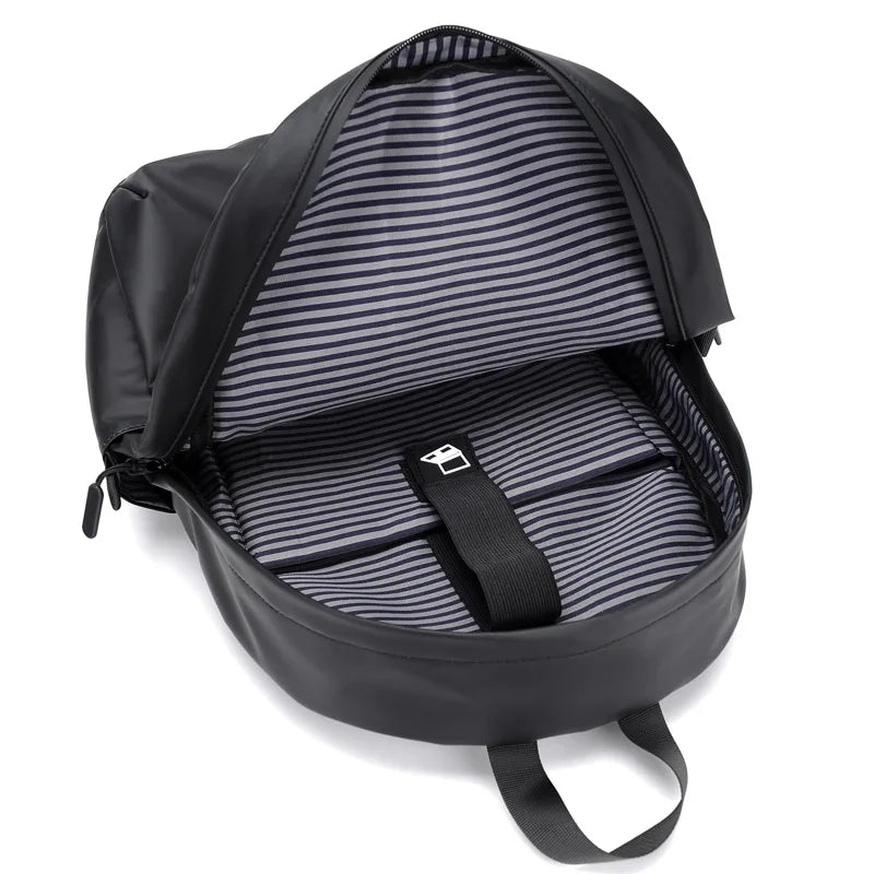 Interior view of a spacious black backpack with striped lining and dedicated laptop compartment.
