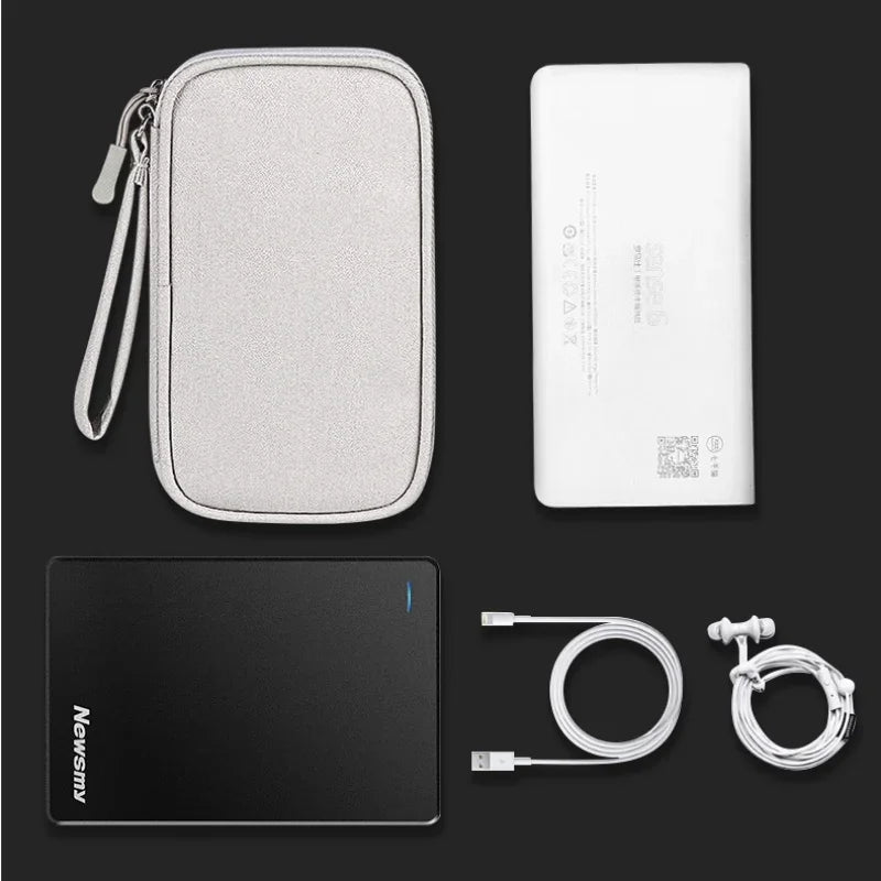 Collection of electronic accessories including a power bank, cable, and case on a dark background