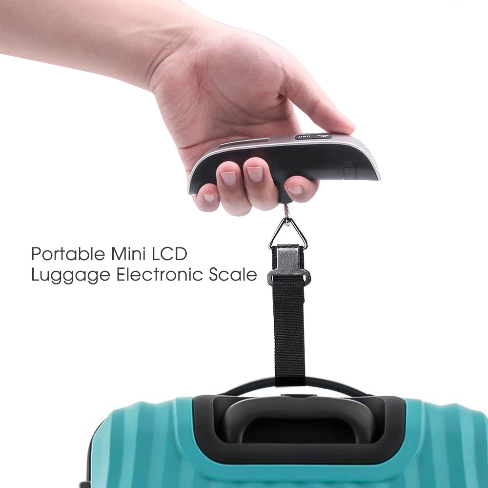 Hand holding a portable mini LCD luggage electronic scale above a teal suitcase.