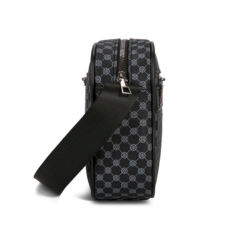 Black patterned crossbody bag with a strap on a white background