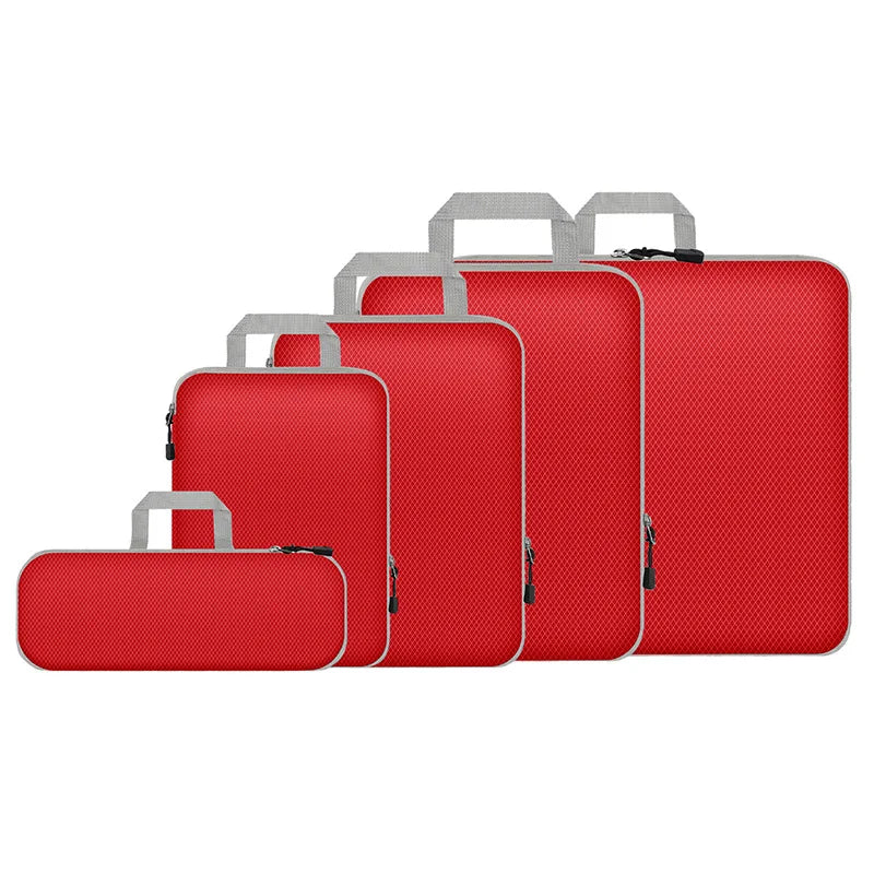 Set of red luggage with silver handles on a white background