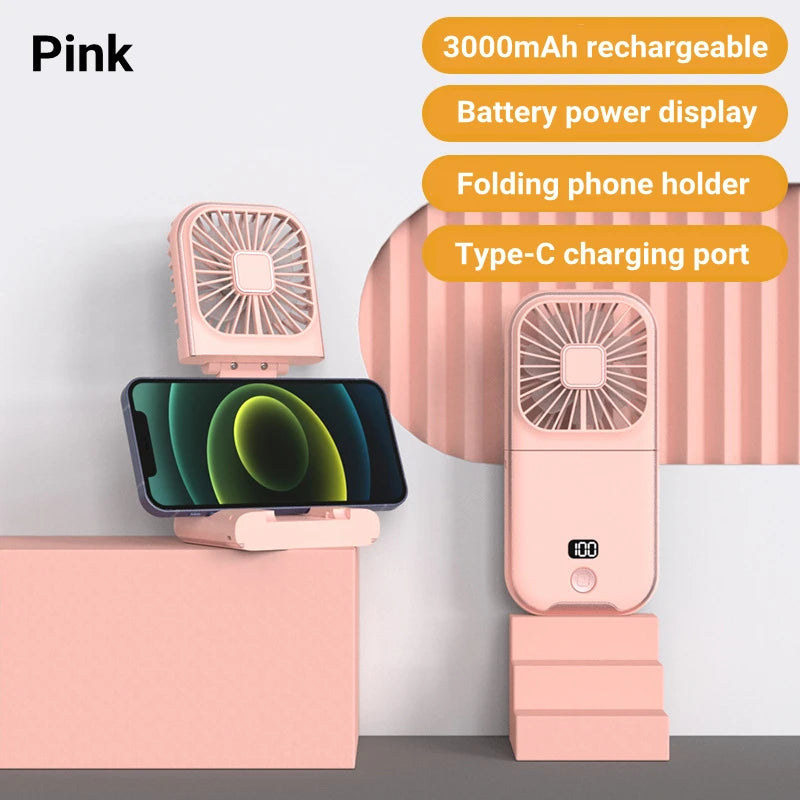 Pink portable fan with phone holder and charging port on a white background