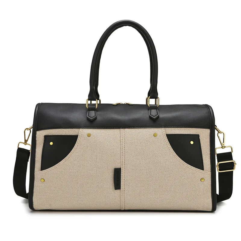Black and beige handbag with gold accents on a white background
