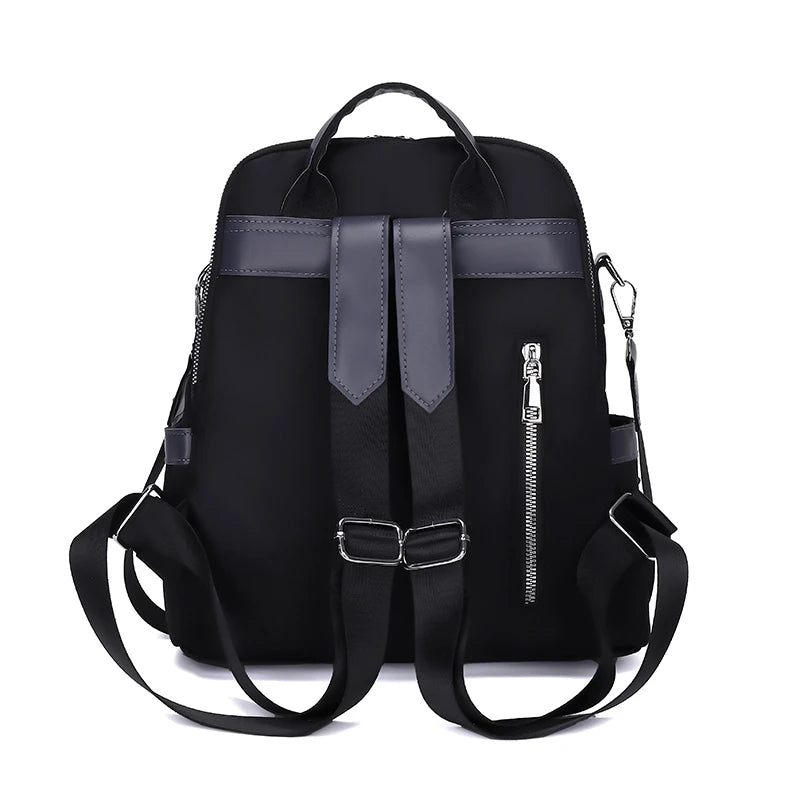Black backpack with leather accents on a white background