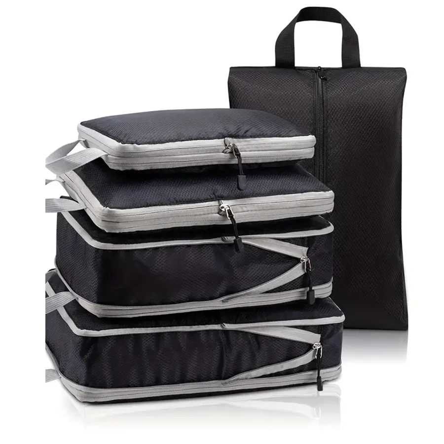 Set of black packing cubes with gray zippers on a white background