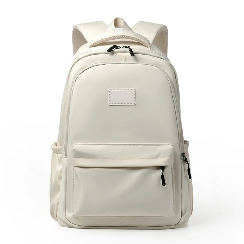 Beige backpack with a front pocket on a white background