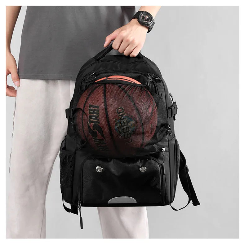 Black backpack with a basketball inside, held by a person on a light gray background
