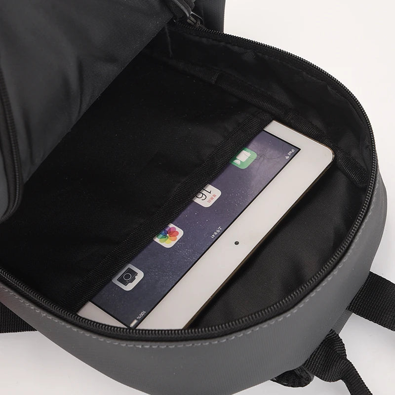 Black backpack with a tablet inside on a white background