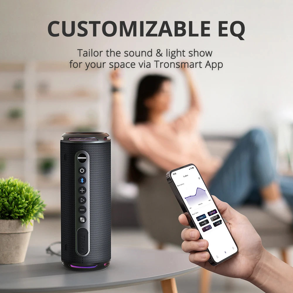Smart speaker with control buttons and a smartphone app on a blurred background of a person using the app.
