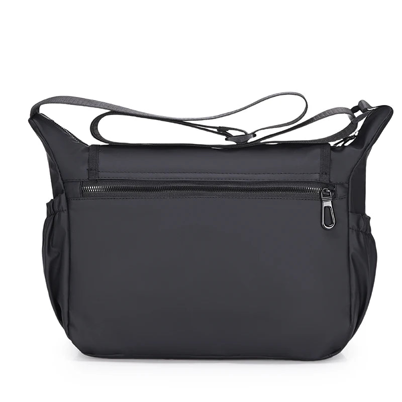 Black shoulder bag with a strap on a white background