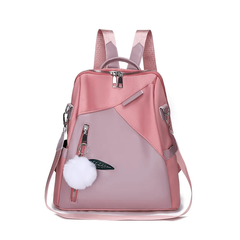 Pink backpack with a white pom-pom on a white background