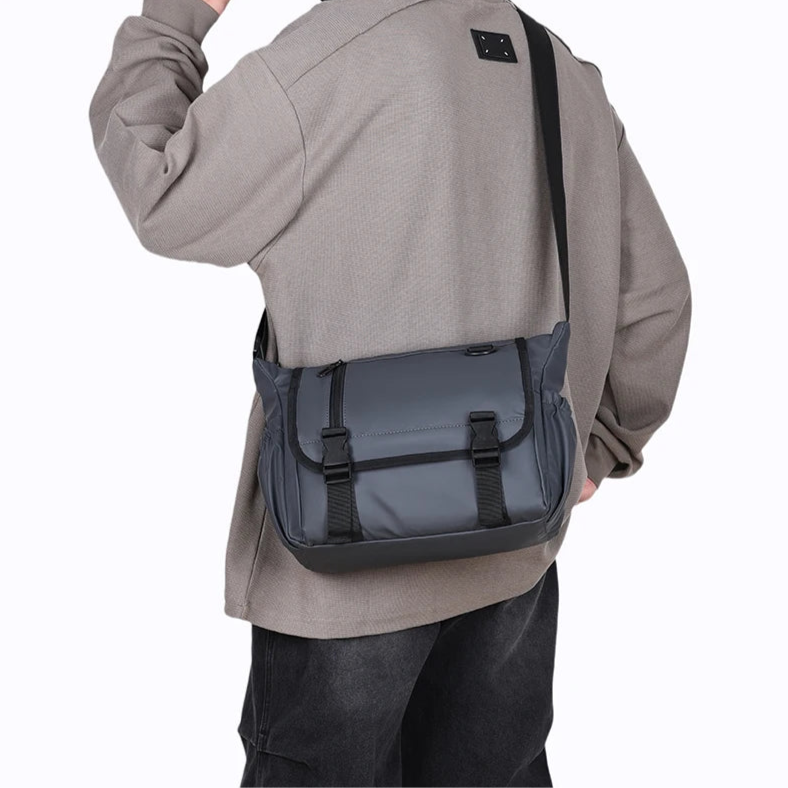 Person wearing a gray shoulder bag on a white background