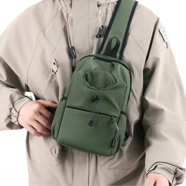Person wearing a beige jacket and black mask with a green backpack on a white background